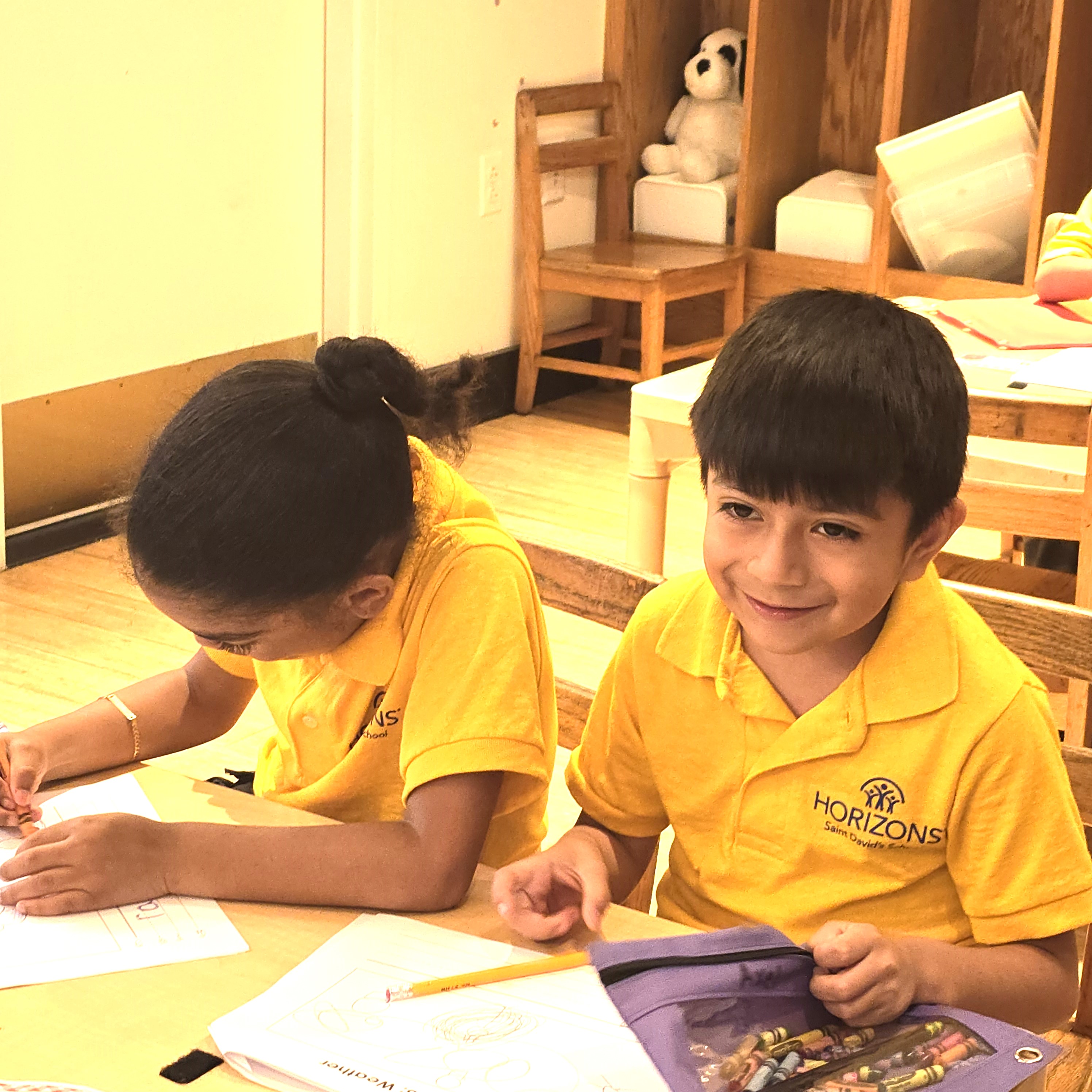Three smiling boys wearing blue Horizons program shirts